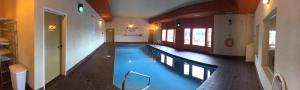 a large swimming pool in a building at New Imperial Suites in Whitecourt
