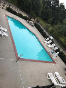 an overhead view of a large swimming pool with lounge chairs at Super 8 by Wyndham Slidell in Slidell