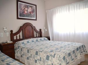 Łóżko lub łóżka w pokoju w obiekcie Hotel Rideamus