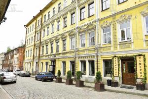 ヴィボルグにあるW Apartament Krepostnaya 13の車並みの黄色い建物