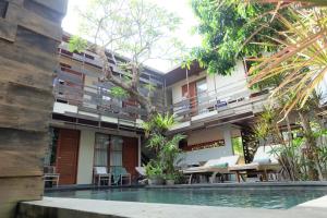 a building with a pool in front of it at Semarandana Bedrooms and Pool in Sanur