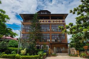 a tall building with a sign that reads real wolfworth at Teak Wood Hotel in Nyaungshwe Township