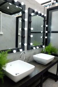 a bathroom with a sink and a mirror at THE TREE Sleep and Space in Trang