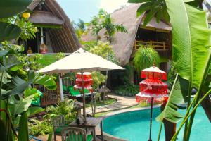 a resort with a swimming pool and a house at Hobbit's House Homestay in Banyuwedang
