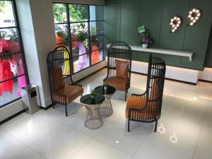 a group of chairs and a table in a waiting room at Hotel 99 Kota Kemuning in Shah Alam