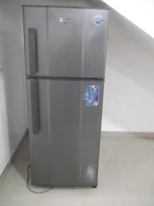 a stainless steel refrigerator sitting in a room at Wishwa Villa in Weligama