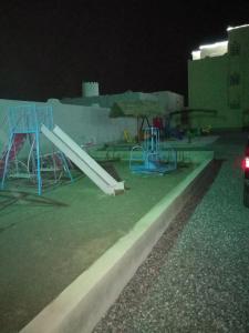 a playground with a slide and a slide at Salassel Al Jabal Al Akhdar Guesthouse in Al ‘Aqar