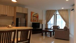 a living room with a kitchen and a living room with a counter at Samsuria Beach Apartment in Kuantan