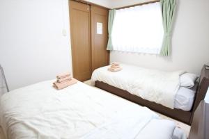 Giường trong phòng chung tại Nagomiya Kyoto Minami-Enmachi