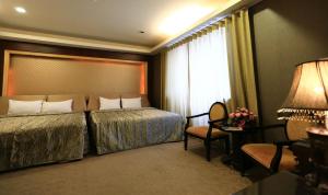 a hotel room with a bed and a window at Wanli Spa & Resort in Wanli