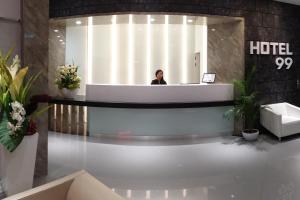 a woman is standing in a hotel lobby at Hotel 99 Kepong in Kuala Lumpur