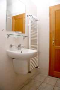 a bathroom with a sink and a mirror at Penzion Budvarka in Hodonín