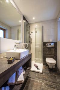 a bathroom with a sink and a toilet at Gästeheim Anna in Längenfeld