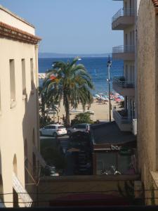 a view of a beach from a building at Hôtel L'Oustaou in Le Lavandou