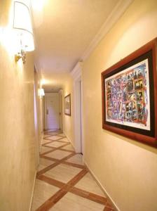 a hallway with a painting hanging on a wall at Hotel Valle in Rome