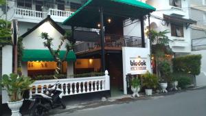 a scooter parked in front of a building at Bladok Hotel & Restaurant in Yogyakarta