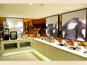 a kitchen with a counter with pots and pans at Jinjiang Inn Changzhi Bayi Square in Changzhi