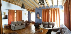 a living room with two couches and a table at Veniata in San Pedro de las Herrerías
