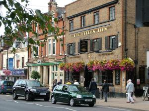 a green car parked in front of a building at Stratford Apartment in Newmarket