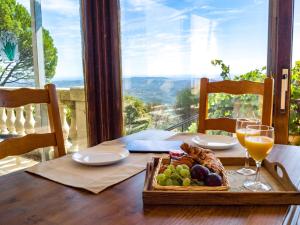 a table with a plate of food and glasses of wine at Domaine du Bois d'Amont in Cabris