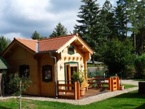 a small house with a porch and a deck at Haus Alwine in Borkheide