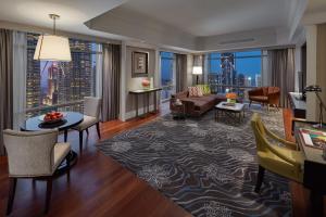 a living room with a couch and a table at Mandarin Oriental, Kuala Lumpur in Kuala Lumpur