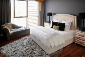 
a bed in a room with a white bedspread at Dream Inn Apartments - City Walk Prime in Dubai
