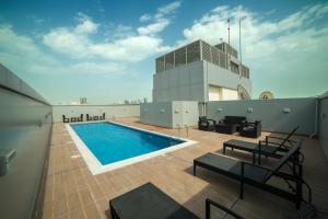 a swimming pool on the roof of a building at Golden Rose Luxury Suites (Royal Executive) in Manama