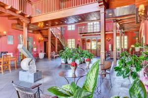 a large room with tables and potted plants at Hotel Spa Villalba in Vilaflor