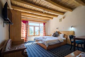 Rúm í herbergi á Siala Guest House