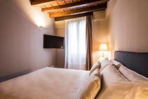 sypialnia z białym łóżkiem i oknem w obiekcie MyPlace Padova Centro Storico w Padwie