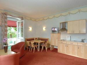 a kitchen and dining room with a table and chairs at Seevilla Wienerroither in Pörtschach am Wörthersee