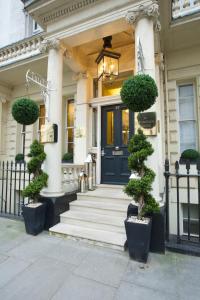 a house with a blue door and some plants at Georgian House Hotel in London