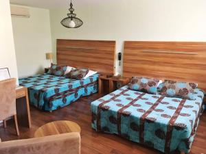 a hotel room with a bed and a couch at Logis Hôtel d'Angleterre in Saint-Calais