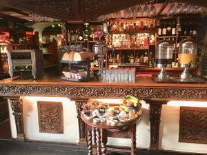 a bar with a large wooden counter in a pub at The Beaufort, Raglan in Raglan