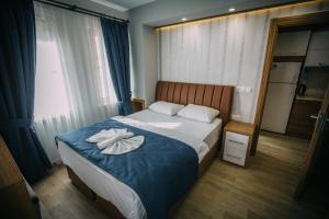 a hotel room with a bed with a towel on it at Turkuaz Apart in Uzungöl
