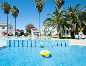 a yellow frisbee in the middle of a swimming pool at Mon Repos Hotel in Ayia Napa