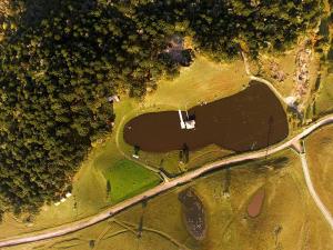 an aerial view of a park with a road and trees at Chalés Rincão Comprido in Canela