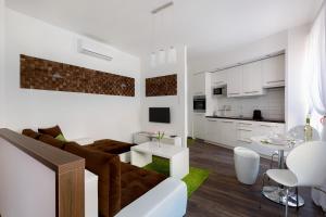 a white living room with a couch and a table at Parliament Dream Home In The Center in Budapest