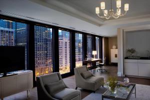 a large living room with a view of a city at The Langham Chicago in Chicago