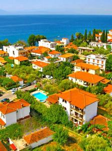 a group of houses on a hill near the ocean at Pagaseon Rooms and Apartments in Kala Nera