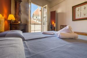 un grande letto con due asciugamani sopra di Typical Florentine Apartment a Firenze