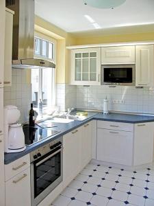 a kitchen with white cabinets and a counter top at Ferienhaus Sundevit Nr 1 Prerow in Prerow