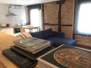 a pile of books sitting on a table in a living room at Suites La Catedral in León