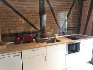 a kitchen with a sink and a counter top at Suites La Catedral in León