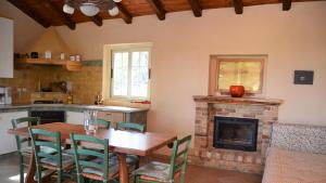 a kitchen with a table and a fireplace at Agriturismo il Roccolo in Pantasina