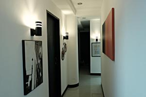 a hallway with pictures on the walls of a building at Transit Point Hostel Mactan Cebu in Mactan