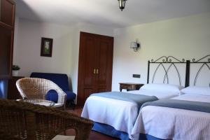 Cama o camas de una habitación en Hotel Mesón del Gallo