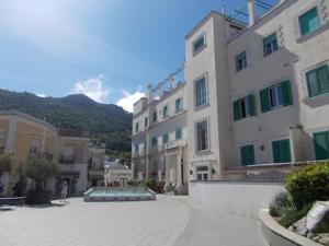 a person walking down a street next to some buildings at Casa Montagnese in Anacapri