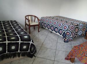 A bed or beds in a room at Pousada Dedo de Deus